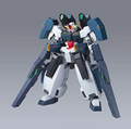 A detailed plastic model of a Gundam mecha robot, featuring a white and dark blue body with red, yellow, and green accents, standing on a neutral gray gradient background.