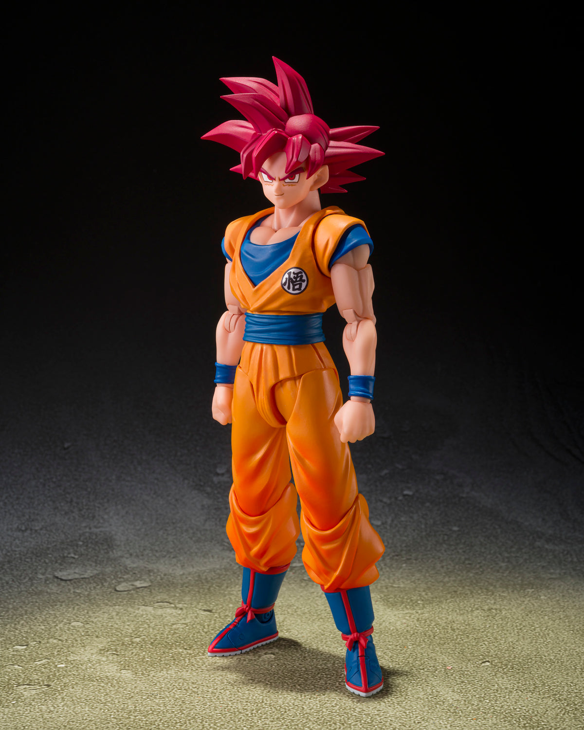 Action figure of a character in orange and blue outfit with red hair on a dark background