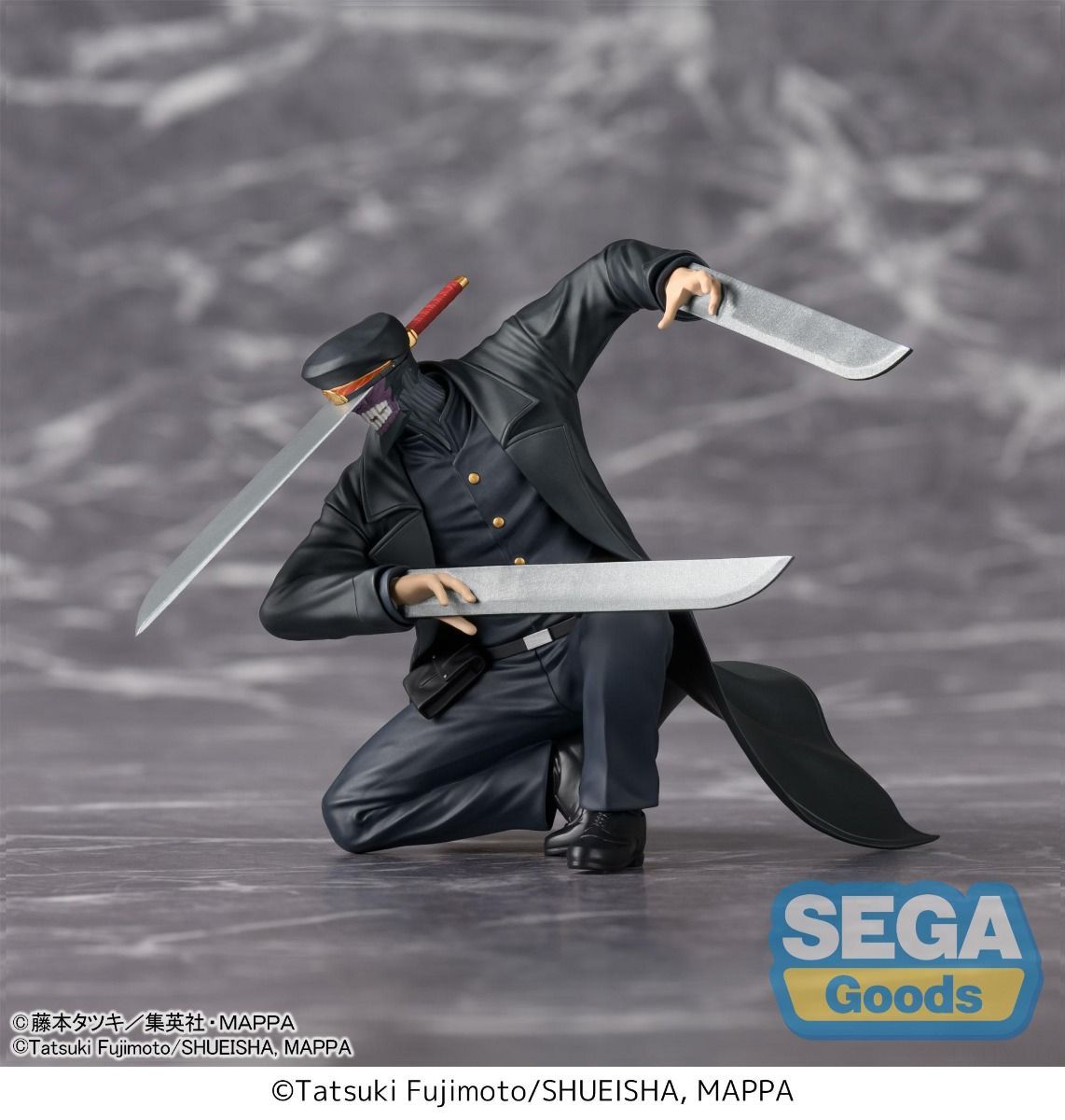 Action figure of a character in a black outfit with two swords on a gray background, featuring the Sega Goods logo.