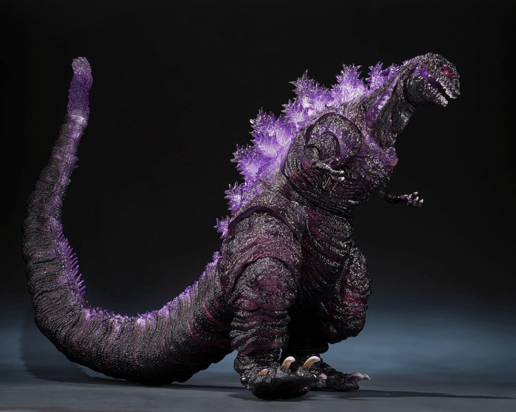 Monster toy with purple energy effect on a dark background