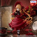 A collectible anime figurine of Shuckler from the Rose Maiden Project, wearing a red dress with black lace trim and a matching red bonnet, posed with floating golden ribbons in a dark, vintage room setting. The brand logo 'FuRyu' is visible in the top right corner.