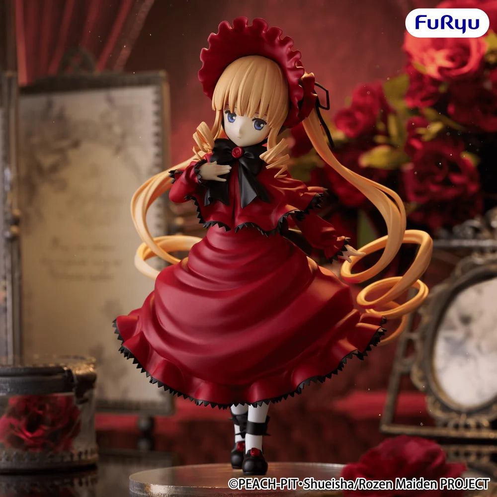 A collectible anime figurine of Shuckler from the Rose Maiden Project, wearing a red dress with black lace trim and a matching red bonnet, posed with floating golden ribbons in a dark, vintage room setting. The brand logo 'FuRyu' is visible in the top right corner.
