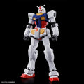 Model kit of a robot with white, blue, red, and yellow colors on a black background.
