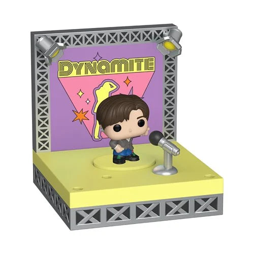 Funko Pop! vinyl figure of a boy with brown hair standing on a yellow stage platform with a microphone and a purple backdrop that reads DYNAMITE.