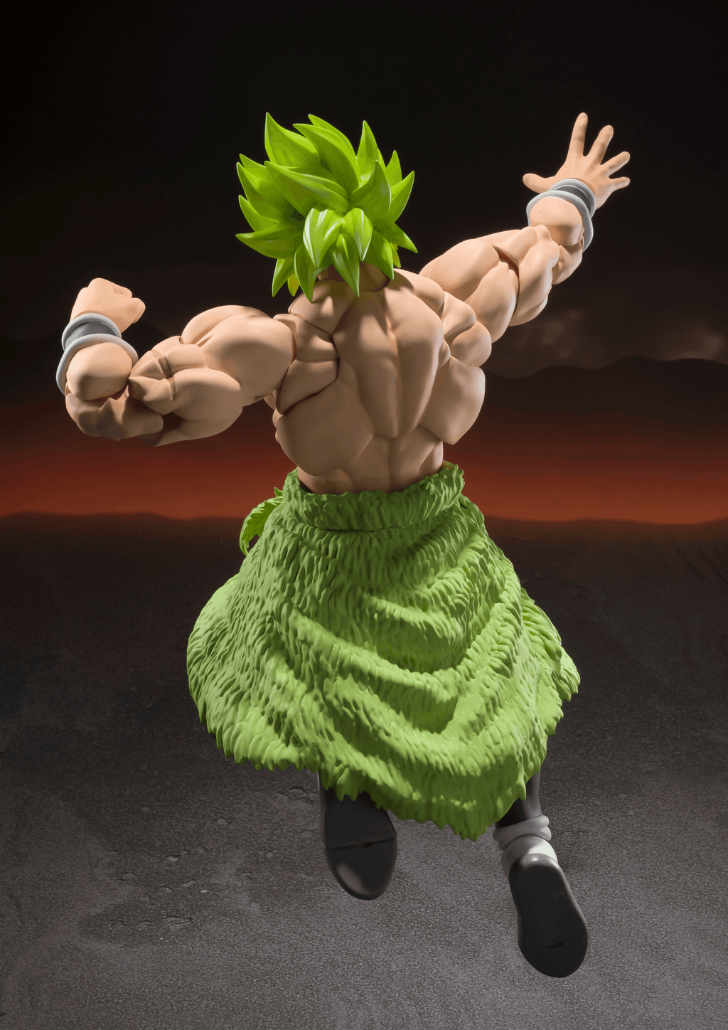 Action figure of a character with spiky green hair and leaf-like outfit against a dark background