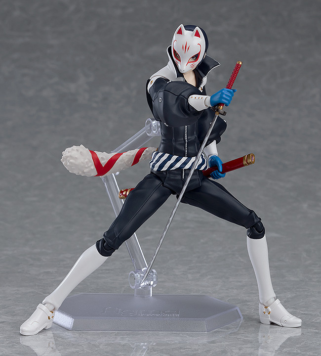 Action figure in a dynamic pose with a weapon on a gray background