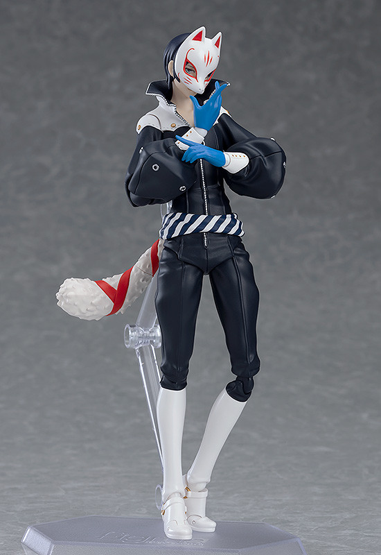 Action figure with fox mask and black outfit on a gray background