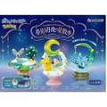 Pokemon Starrium Series Dreamy Moonlit Star Stroll toy set packaging, featuring three fantasy figurines: a mouse by a tree in a teal cup, a Pikachu and a girl under a crescent moon on a pink base, and a blue dragon under a glowing green crescent on a teal base. The box has a blue starry night design with RC-Mont branding.