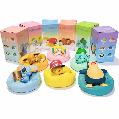 A collection of six Pokemon character bath toys resting in colorful round beanbag-style bases, with their matching retail boxes lined up behind them on a white background.