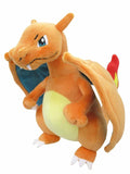 Plush toy of a dragon-like creature with orange body, blue chest, and red tail on a white background