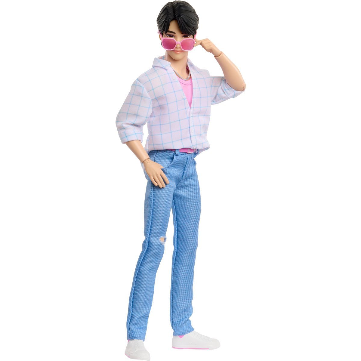 Fashion doll wearing a plaid shirt, pink top, blue jeans, and white shoes on a white background