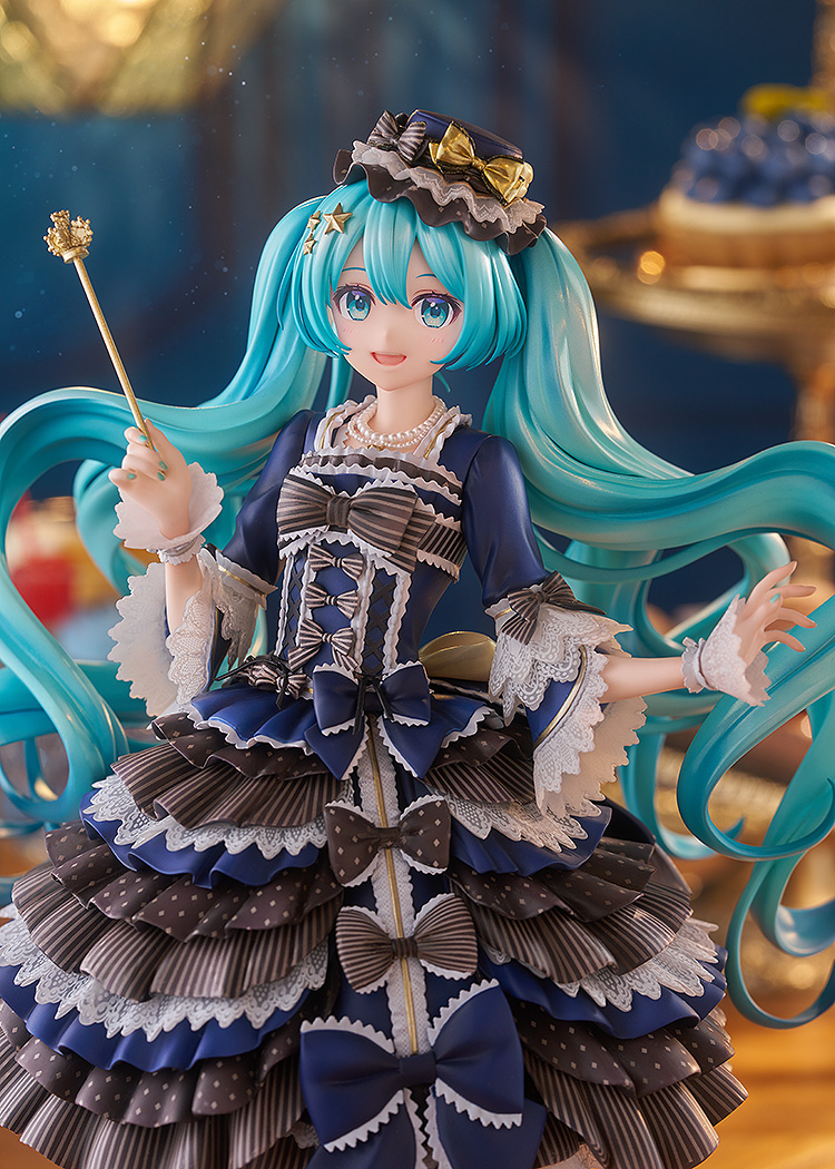 Detailed figurine with blue hair and elaborate dress holding a wand.