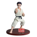 Figure of a martial artist in a white kimono on a red base with 'Confirming' text