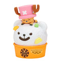 Toy figure of a character with a pink hat and deer antlers on top of a white creature with a smile, all in an orange holder with Banpresto branding.