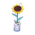 A 3D wooden sunflower model with yellow petals, a brown textured center, teal leaves and stem, and a decorative blue patterned base, shown on a plain white background.
