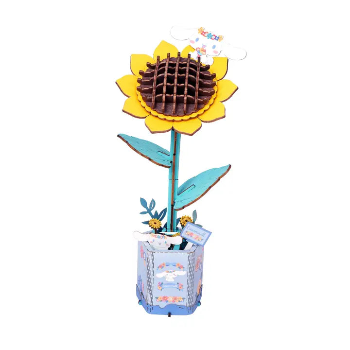 A 3D wooden sunflower model with yellow petals, a brown textured center, teal leaves and stem, and a decorative blue patterned base, shown on a plain white background.