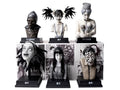 Collection of black and white character busts on a display stand with comic book panels in the background.