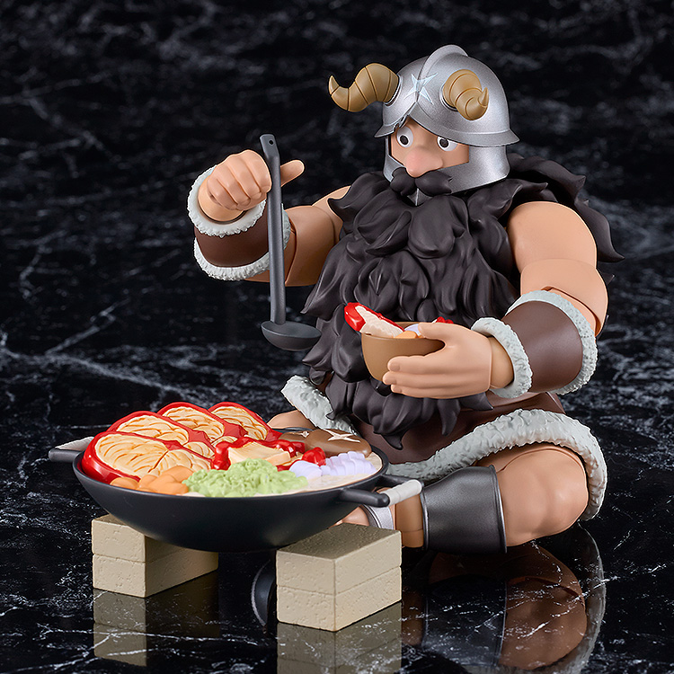 Viking figurine cooking on a black surface