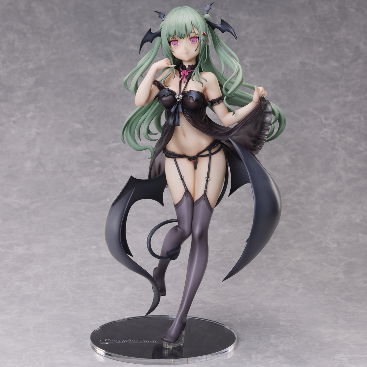 Anime figurine with green hair and black outfit on a gray background