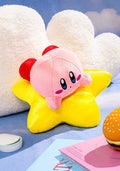 Plush toy resembling a pink character with a star-shaped body on a blue background