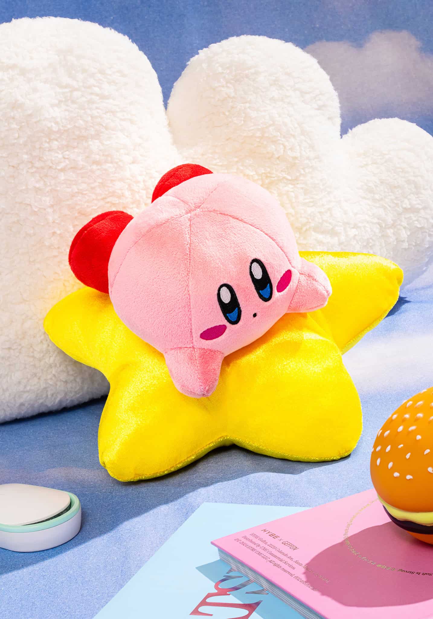 Plush toy resembling a pink character with a star-shaped body on a blue background