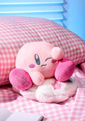 Pink plush toy with a happy expression on a checkered background
