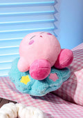 Plush toy with pink face and blue body on a checkered surface