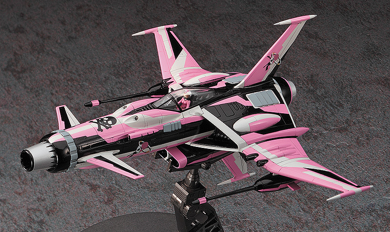 A pink and black futuristic fighter jet model displayed on a stand against a textured gray background.