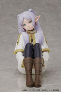 Figurine of a character with purple hair and elf-like ears on a gray background