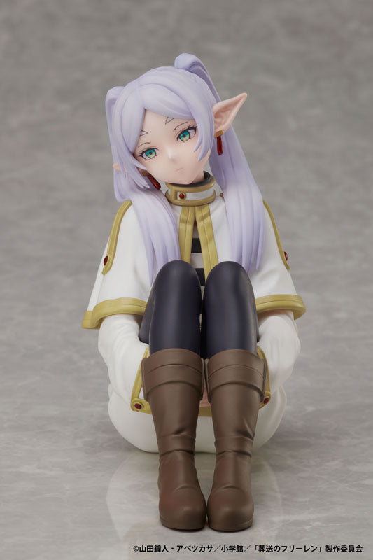 Figurine of a character with purple hair and elf-like ears on a gray background