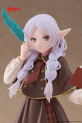 Elf-like character figurine with purple hair and pointed ears holding a feathered staff and book.