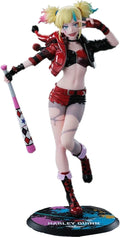 Harley Quinn figurine with colorful hair and outfit on a white background