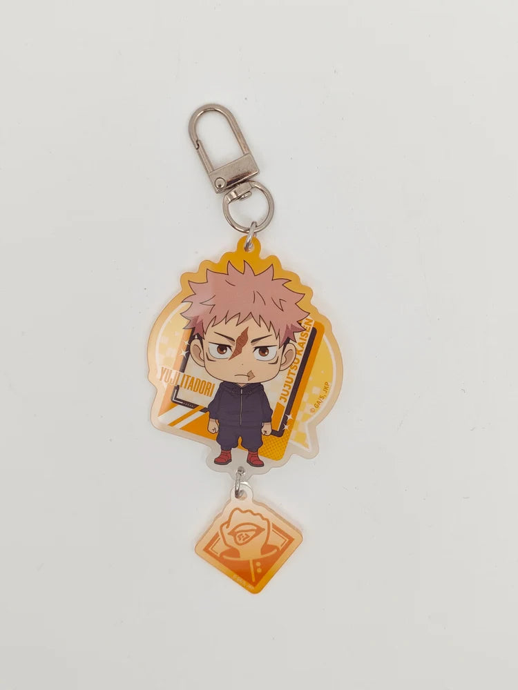 An acrylic keychain featuring a chibi anime character with spiky pink hair, attached to a silver lobster clasp and a small orange tag, photographed on a plain light background.