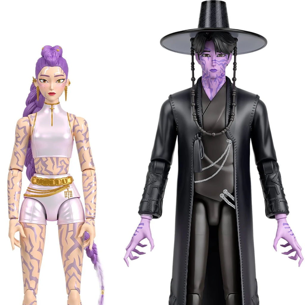 Two stylized action figures on a plain white background: a female figure with purple hair, pale skin, and tan patterned tattoos wearing a white and gold outfit, and a male figure with purple skin, black hat, and long black coat with silver chain details.