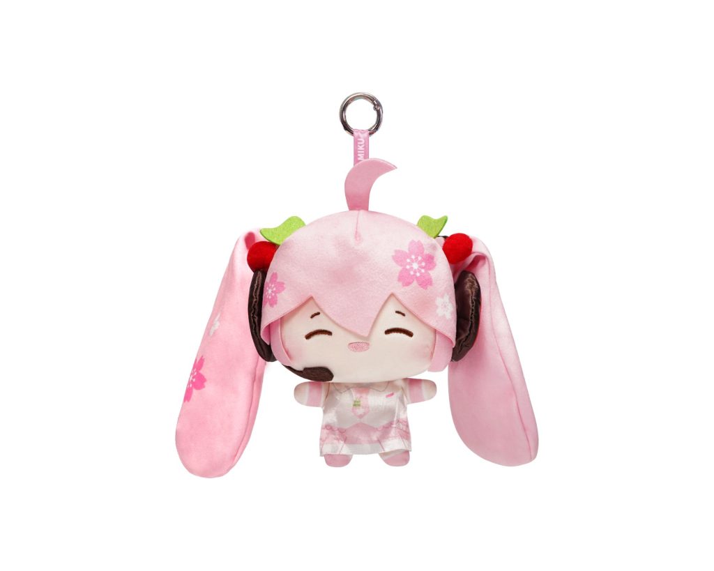 A pink plush character keychain featuring long floppy ears, cherry blossom details, and a metal key ring at the top, shown on a plain white background.