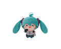 A plush toy of Hatsune Miku with turquoise twin-tails, a pink and gray outfit, and a small keychain ring at the top, shown against a plain white background.