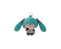 A plush keychain of Hatsune Miku with turquoise hair, a small smiley face, and a metal key ring at the top, shown on a plain white background.