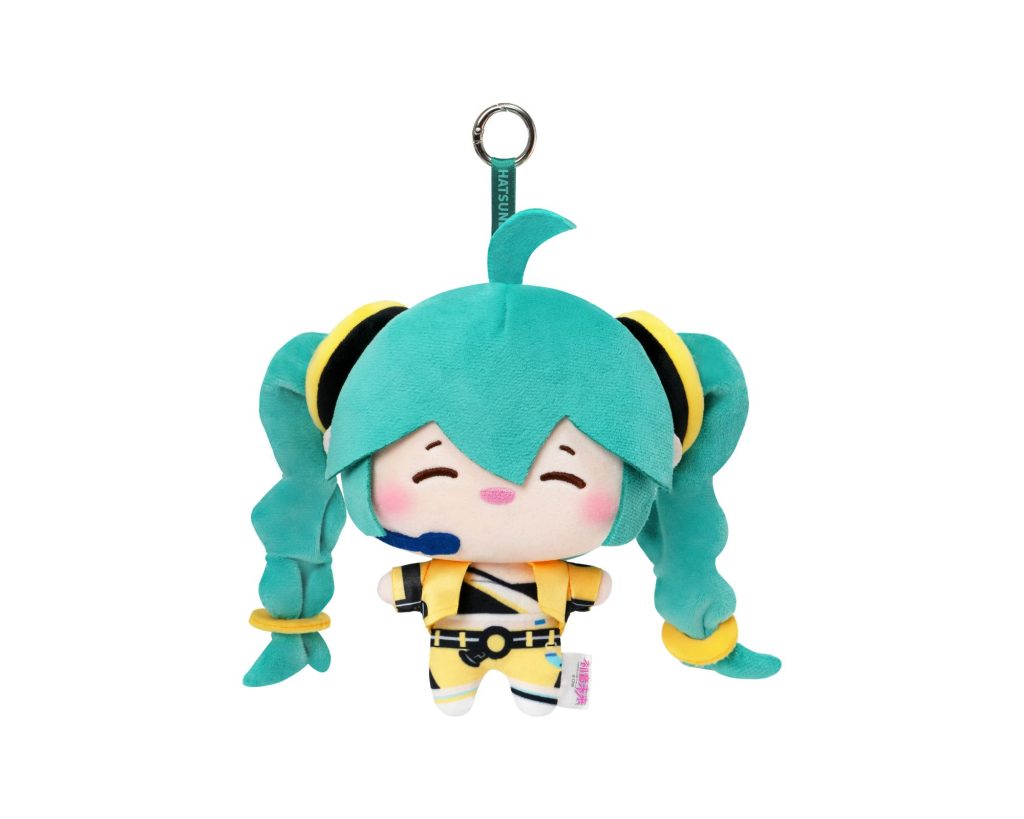 A plush character keychain featuring a turquoise and yellow anime-style girl with twin tails, shown against a plain white background.