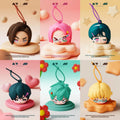 Six silicone phone pouches with different colored hair and expressions on a pink background.