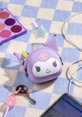 Purple cartoon-style pouch with a face on a checkered surface with makeup and phone.