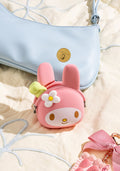 Pink bunny-shaped pouch with a flower design on a light background