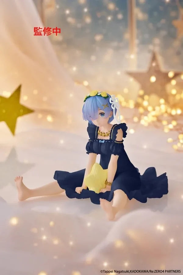 Figurine of a character with blue hair and a yellow dress on a soft surface with star decorations.
