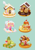 Set of small, colorful gingerbread house-themed figurines on a light green background