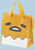 Yellow bag with a cartoon face design on a light blue background
