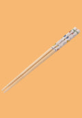 Pair of wooden chopsticks with colorful handles on an orange background