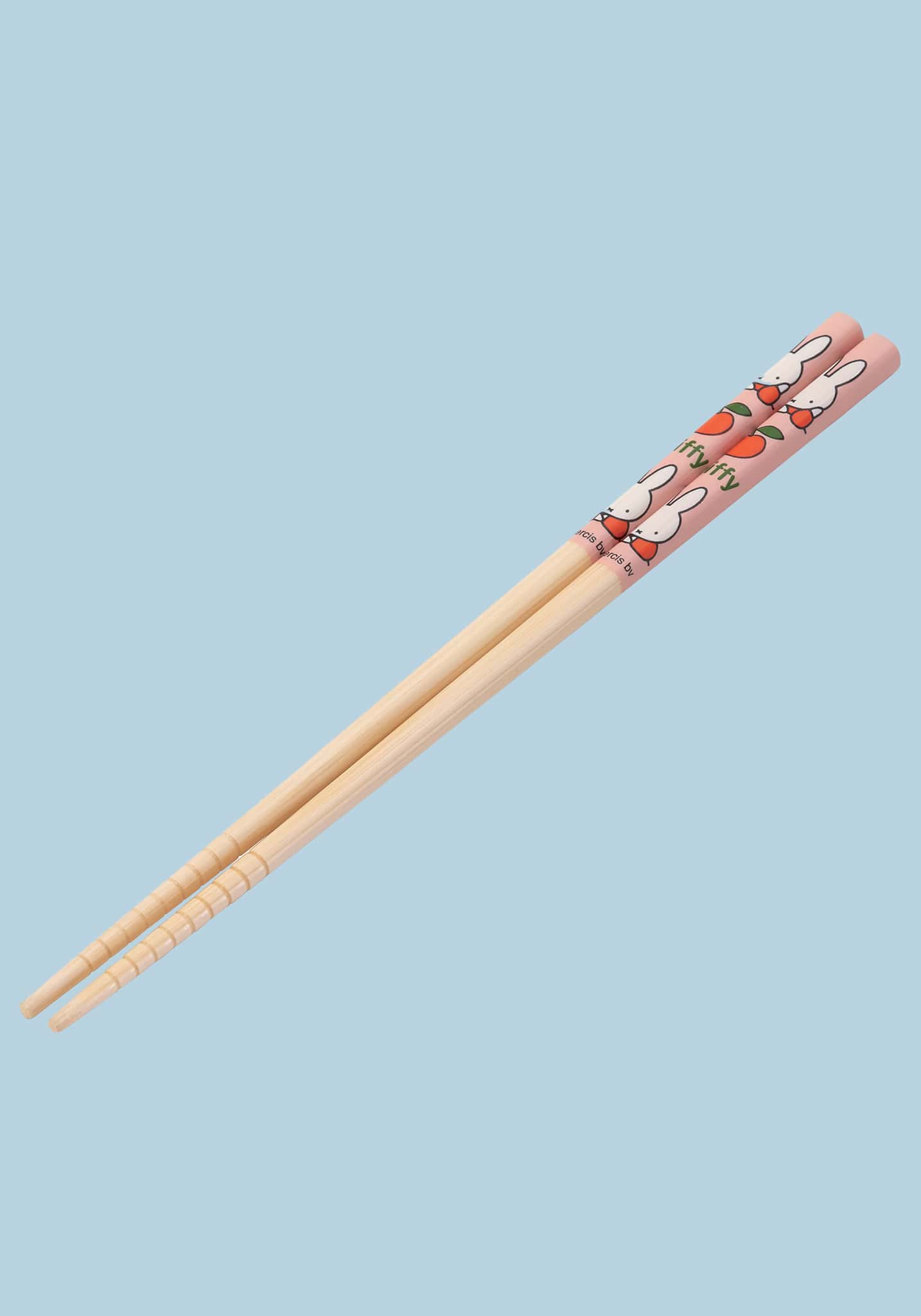 Chopsticks with cartoon rabbit design on a light blue background