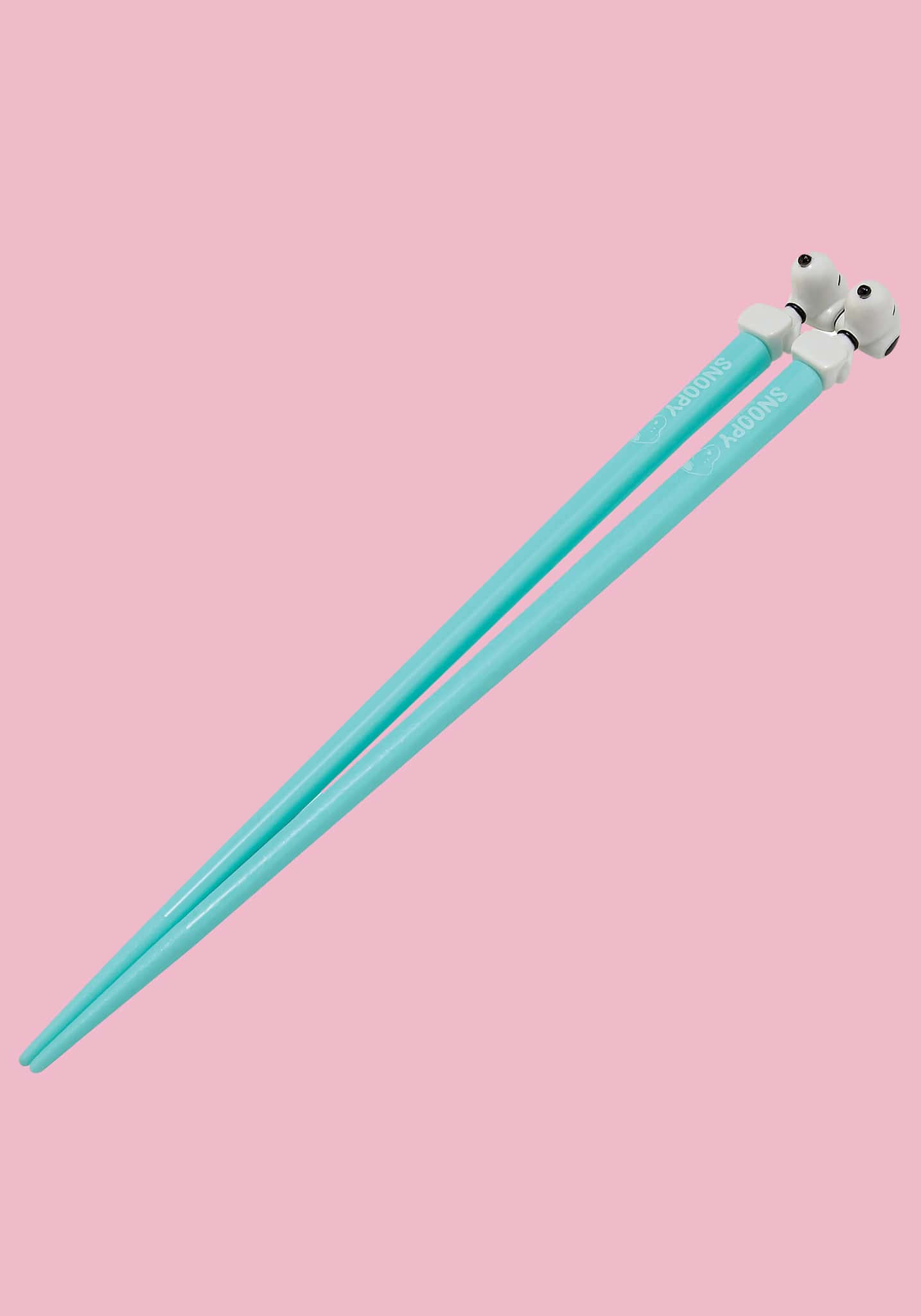 Light blue chopsticks with panda ends on a pink background
