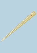 Pair of gold chopsticks on a light blue background