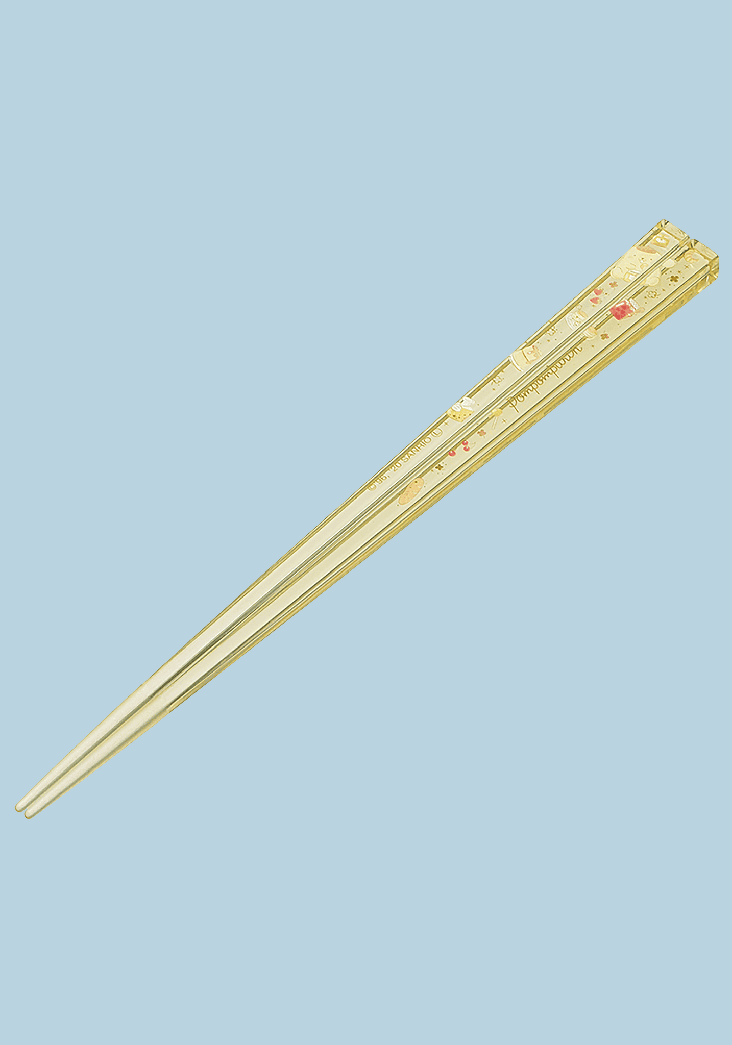 Pair of gold chopsticks on a light blue background
