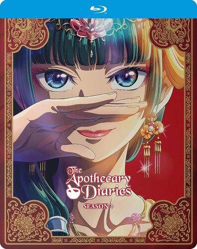 The Apothoecary Diaries Season 1 Blu-ray cover featuring an anime-style illustration of a woman with blue eyes, teal hair, and gold hair accents, set against a red background with ornate gold borders. The Blu-ray case top is blue.